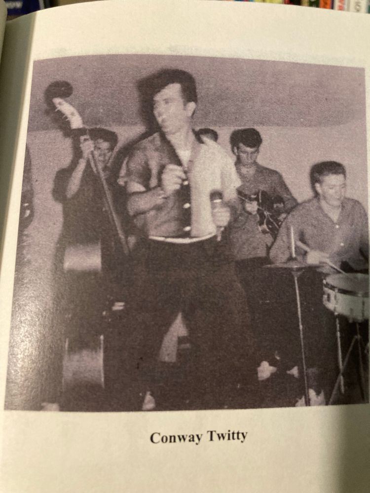 Conway Twitty in the 50s, looking like a rockabilly cat. Guitarist, drummer, and bassist (Jimmy Evans) are visible 