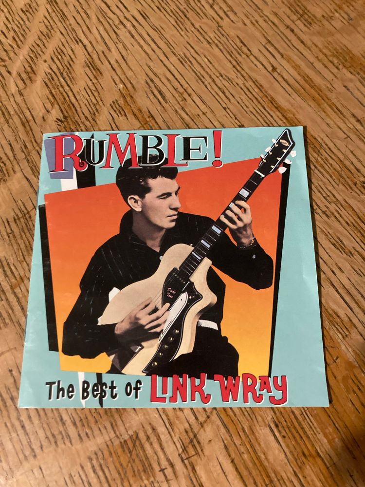 Link Wray “Rumble The Best of link Wray” cd with cover photo of Link playing a Supro Dual Tone electric guitar 