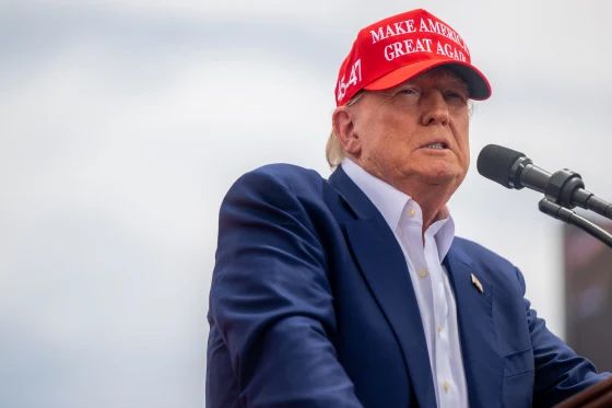 Trump wearing a MAGA hat during a speech