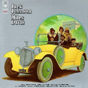 The cover of Miles Davis’ Jack Johnson album, showing a group of people in a yellow vintage Rolls Royce. 