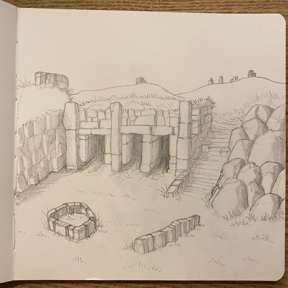 An ancient ruined tomb set into a rocky ridge-side. Stairs the right of the tomb entrance lead to grassy hills above. Stone blocks can be seen littering the landscape.

The tomb-face shows three stoney entrances. Before the tomb is littered more stones.