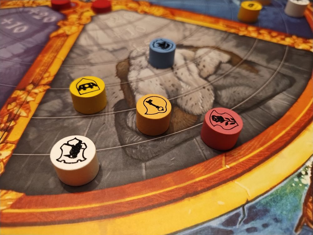 Player discs on different steps of the fur sections of the Medici board.