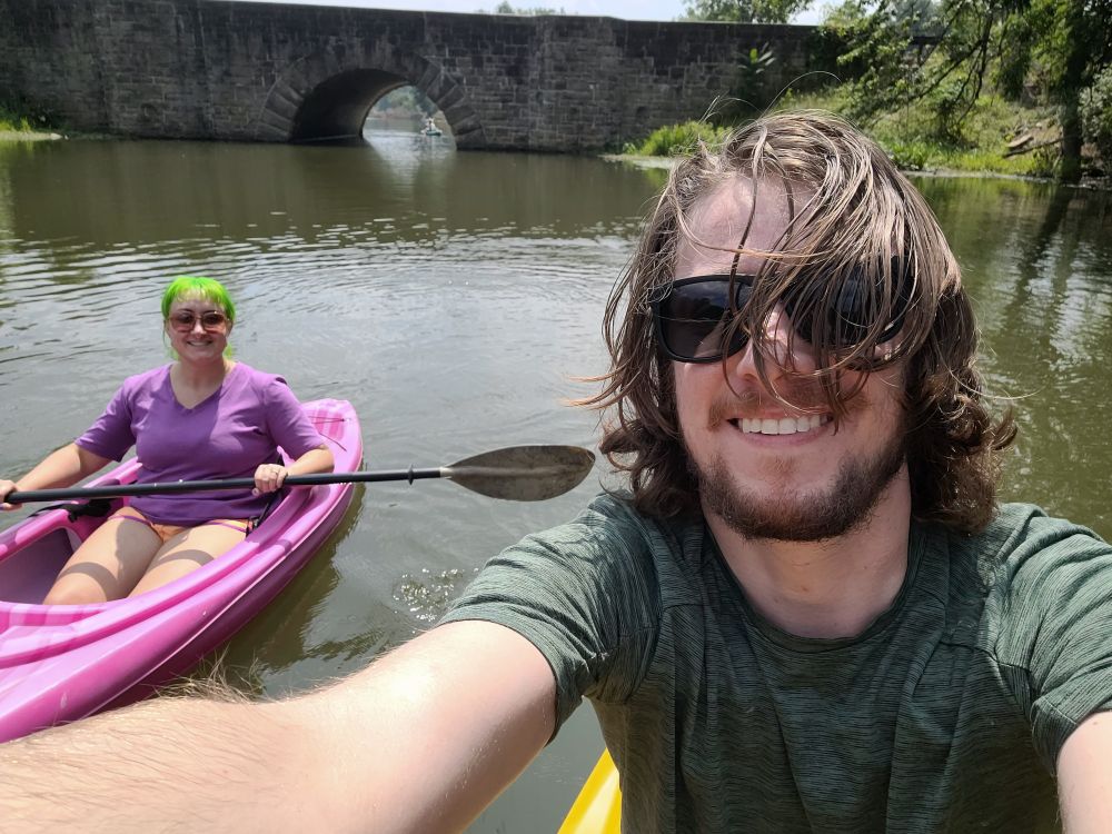 A selfie of a paddleboarder and kayaker