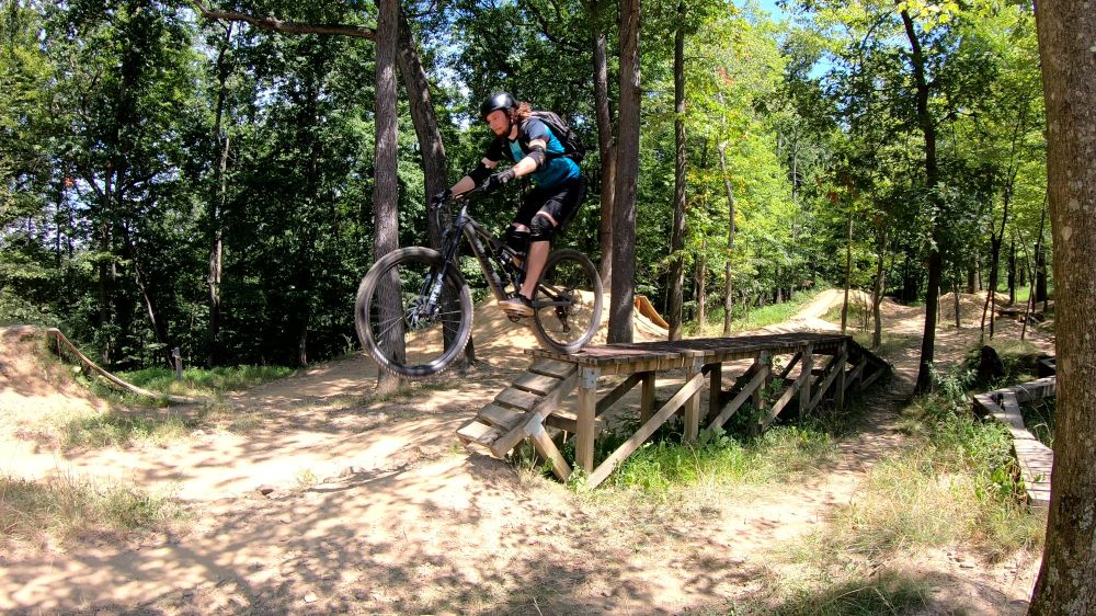 A mountain biker on a wooden drop