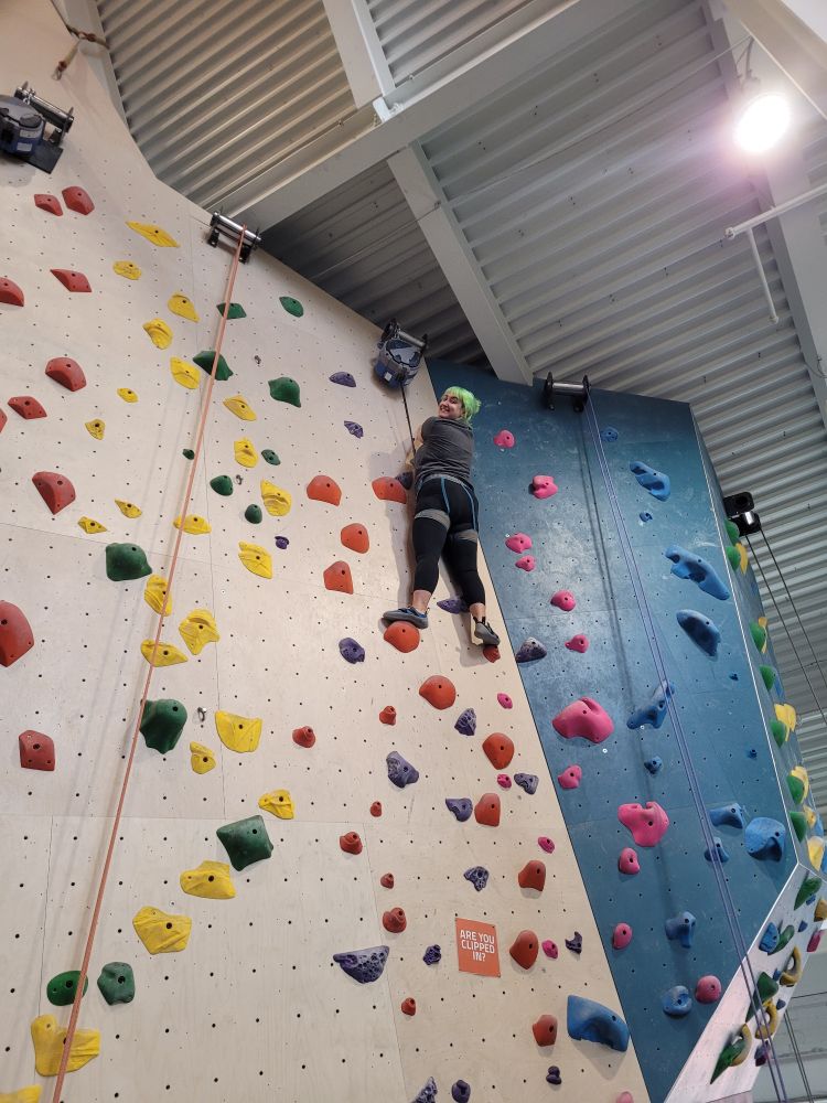 A female climber at the top of an autobelay route. This poster is proud of his wife Maria!