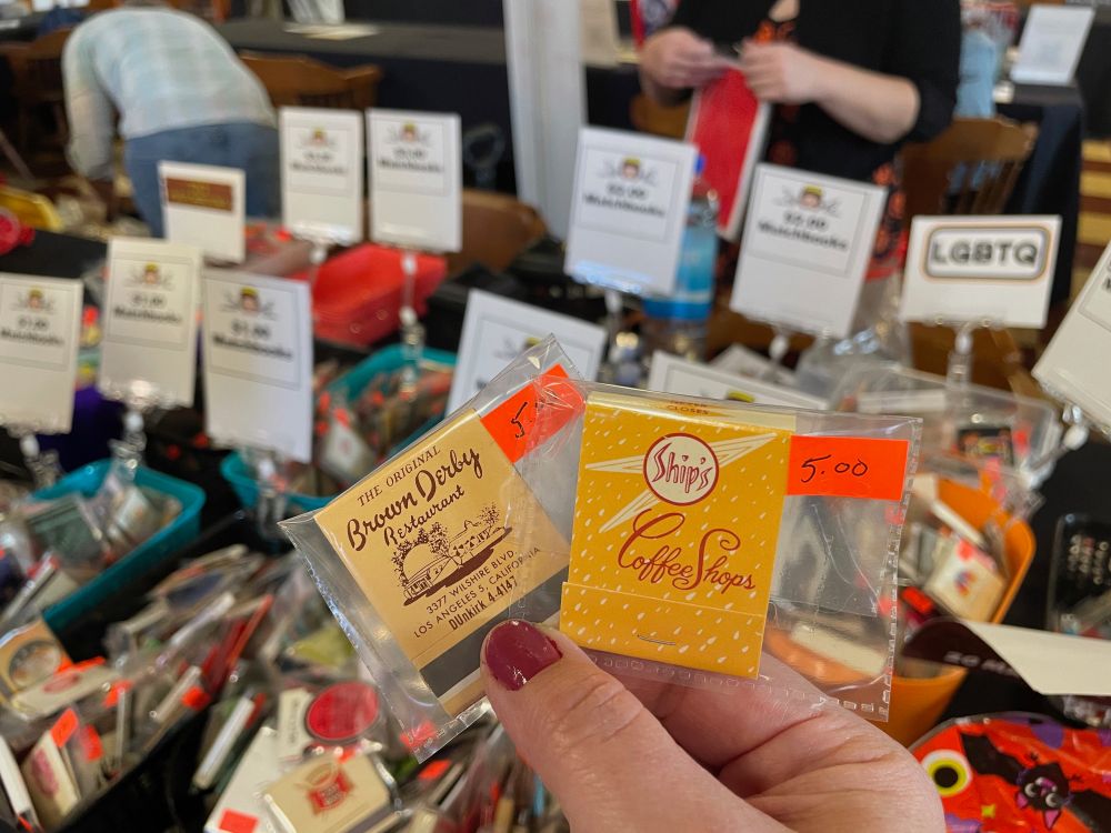 Angelus Matchcover Club has a popular display at the Archives Bazaar as it has a number of vintage matchbook covers for sale. This 2024 photo shows matchbook covers from the Brown Derby and Ship's Coffee Shops.