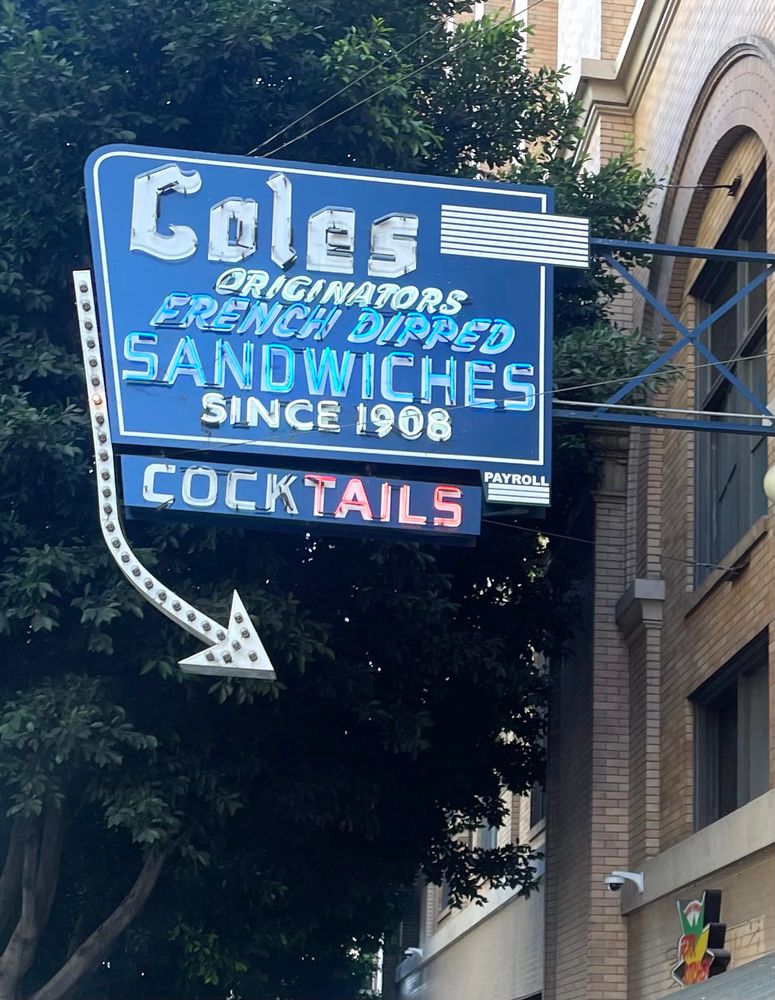 The Cole’s neon sign (as seen in the day time) that reads “Cole’s Originators French Dipped Sandwiches Since 1908. Cocktails.”