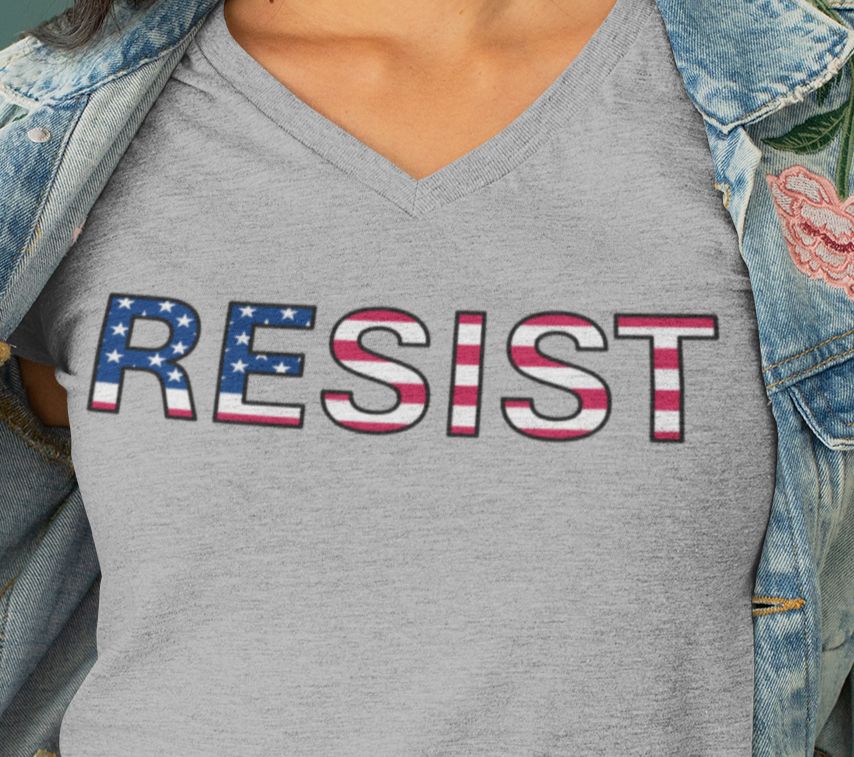 A gray v-neck t-shirt with the text "resist" in an American flag motif.