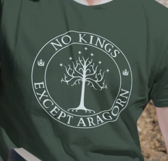 A green t-shirt with the text "No kings except Aragorn" and a graphic of the white tree of Gondor with seven stars above it and two crowns of the king of Gondor.