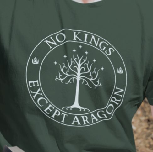 A green t-shirt with the text "No kings except Aragorn" and a graphic of the white tree of Gondor with seven stars and two crowns of the king of Gondor.