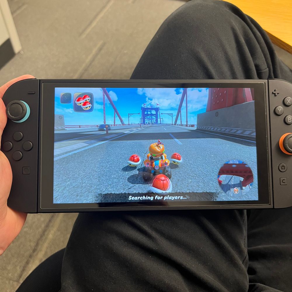 Me holding a Nintendo Switch 2 with Mario Kart World on the screen.