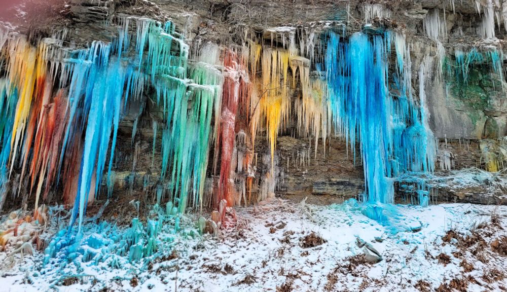 A rainbow of colored ice on a hillside.