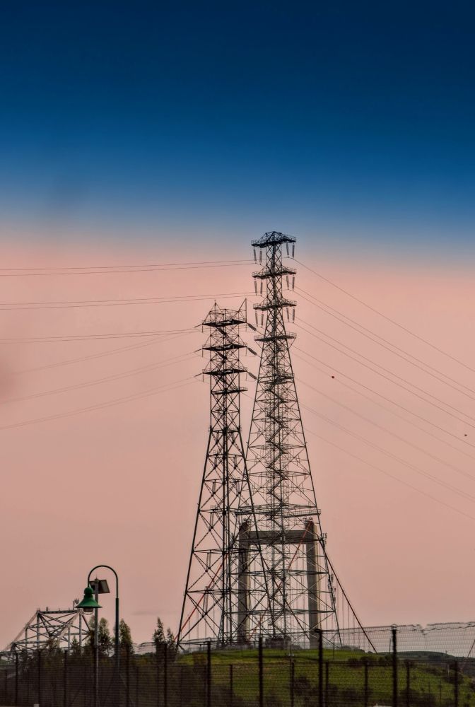 a couple of transmission towers with a tiny bit of a bridge showing.
taken in east bay california