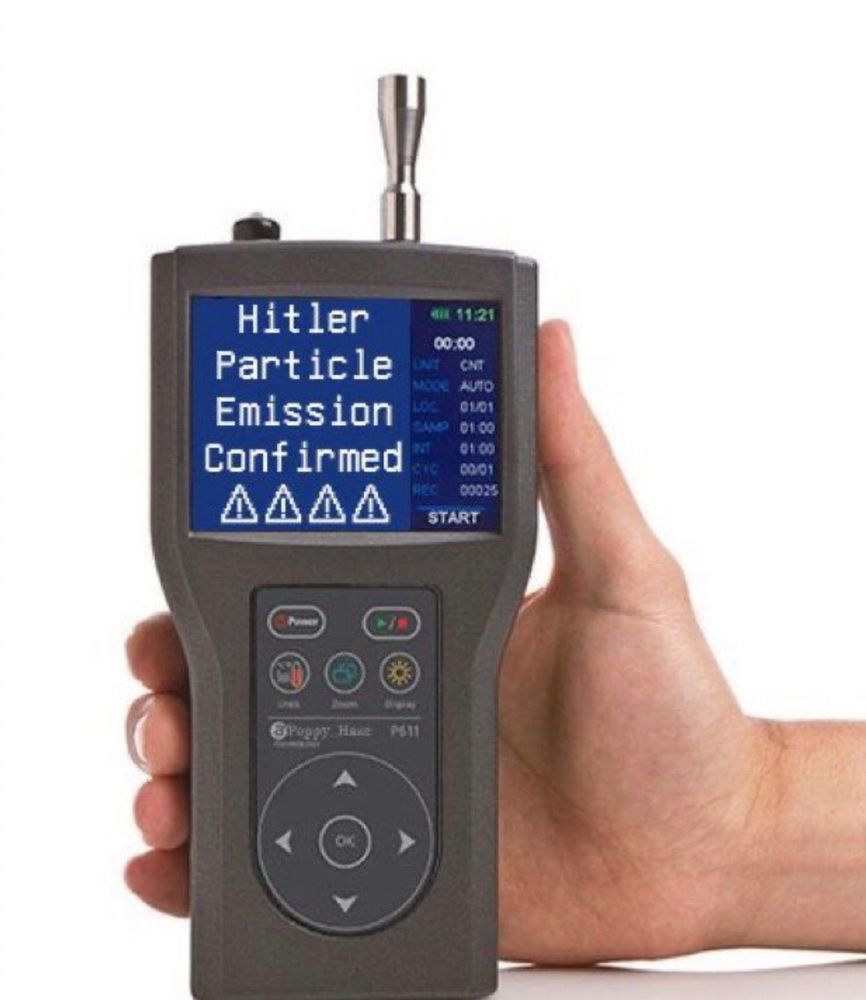 a hand holds a device that looks like a walkie talkie. the device's screen says "Hitler Particle Emission Confirmed"