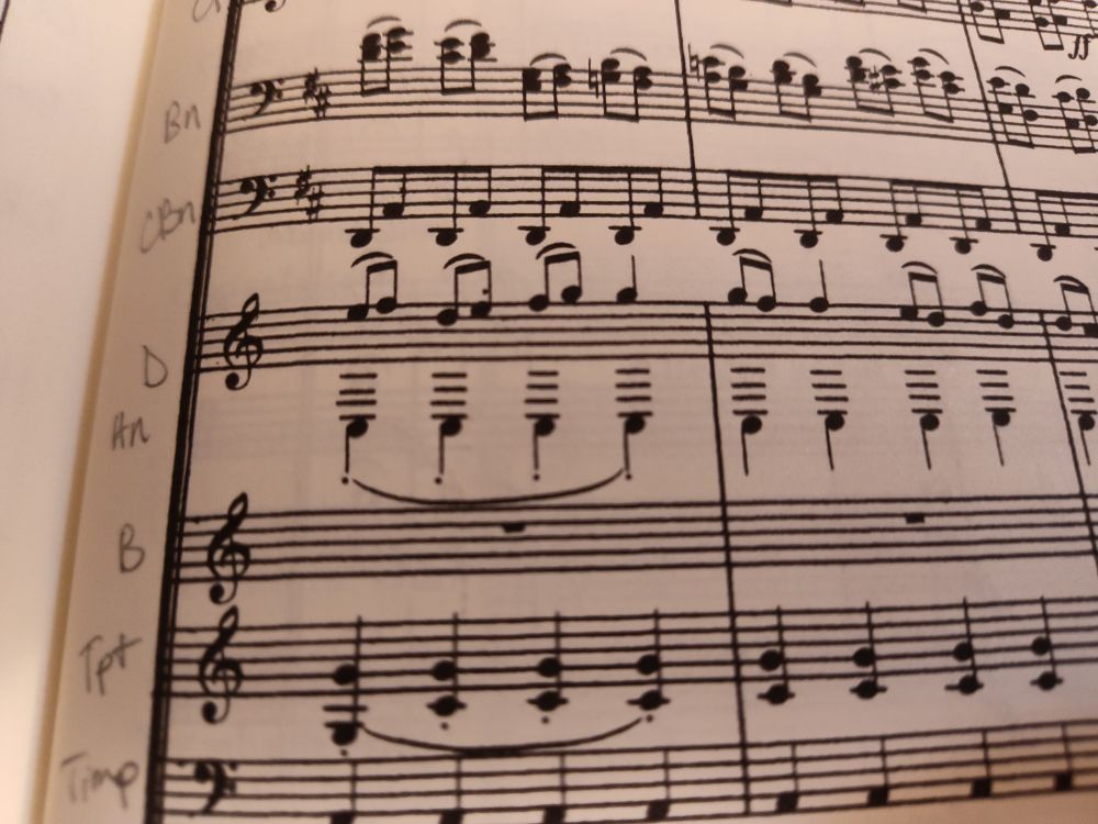 an excerpt from the finale of Beethoven's 9th symphony showing the first and second horns in D. The first horn is playing around the top of the (treble clef) staff, while the second is playing a repeated low C several ledger lines below the staff.