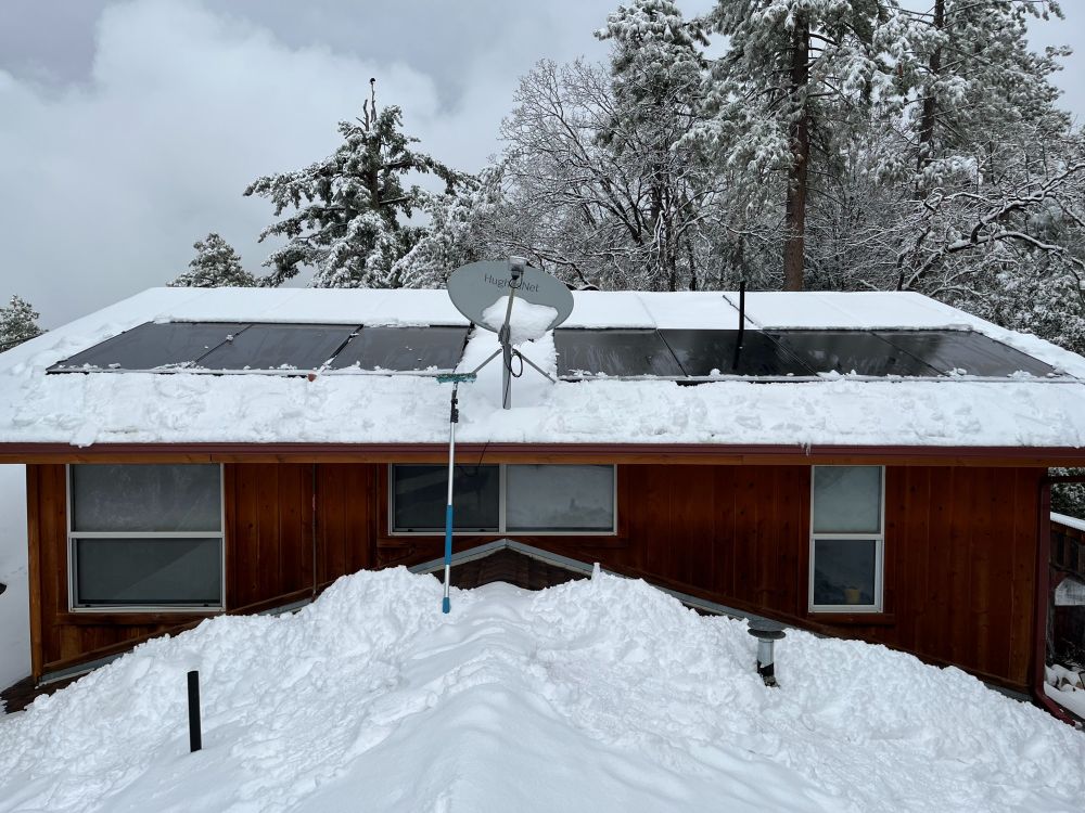 picture of snow-covered roof ... snow removed from solar panels