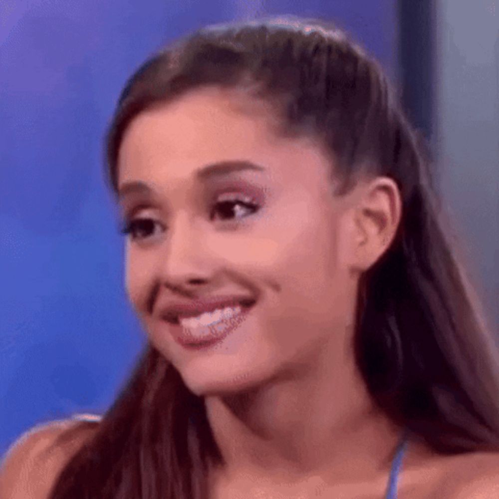 ariana grande is smiling and making a funny face while talking on a television show .