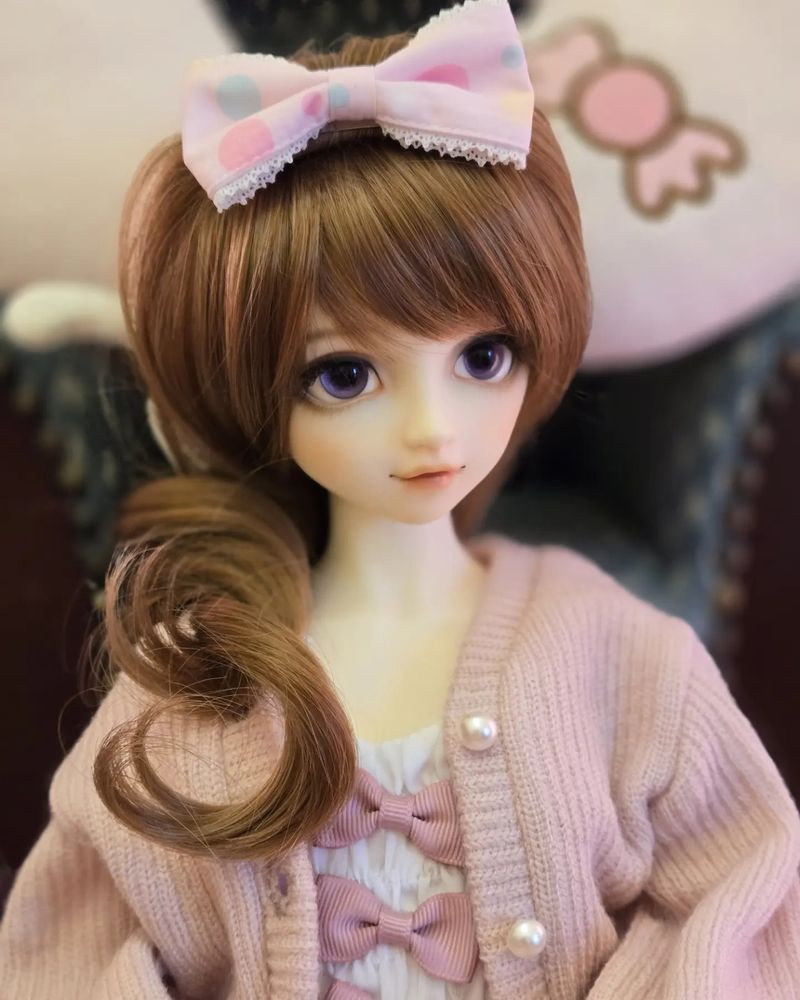 A ball jointed doll, model volks fcs-45 with a pink bow themed outfit