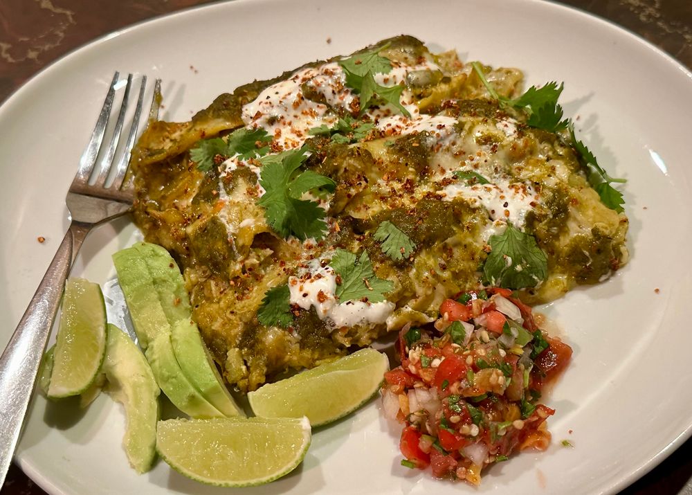 Green enchiladas with lime, avocado, and pico de gallo.