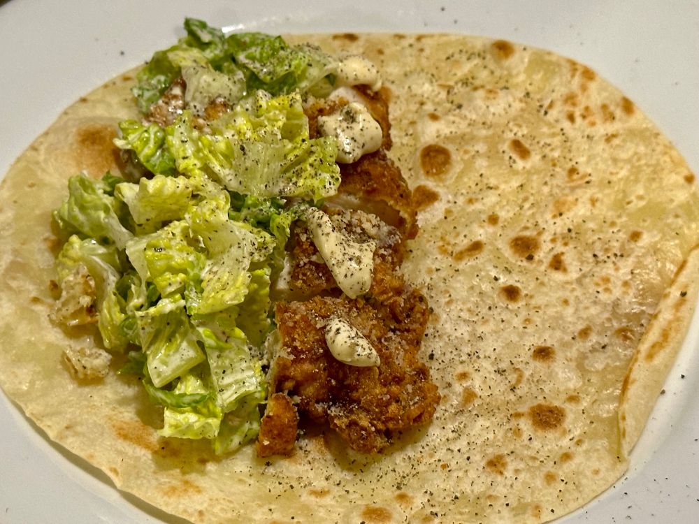 A chicken Caesar snack wrap on a plate