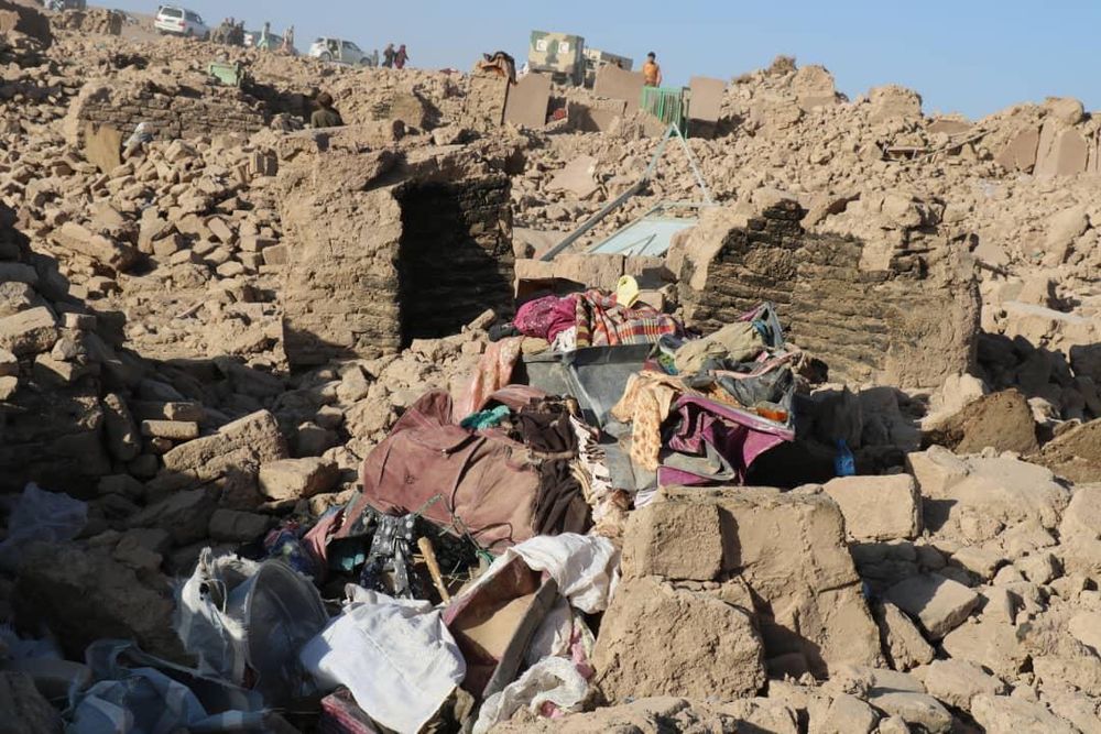 Bild aus dem Erdbebengebiet bei Herat, zerstörte Häuser soweit der Blick reicht, dazwischen ein paar Habseligkeiten.