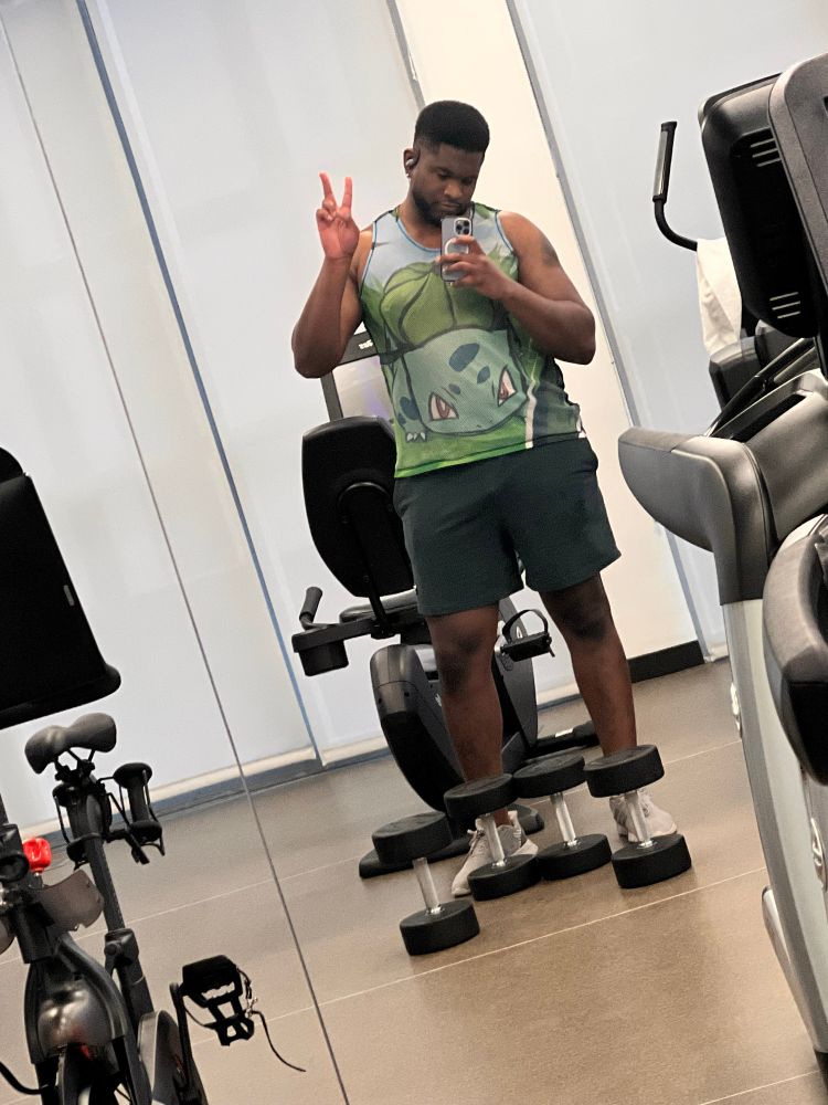 Cute boy in bulbasaur tank top at the gym.
