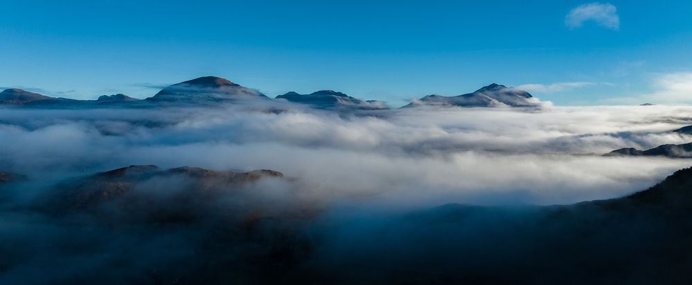 Aerial shot of mountains and clouds.