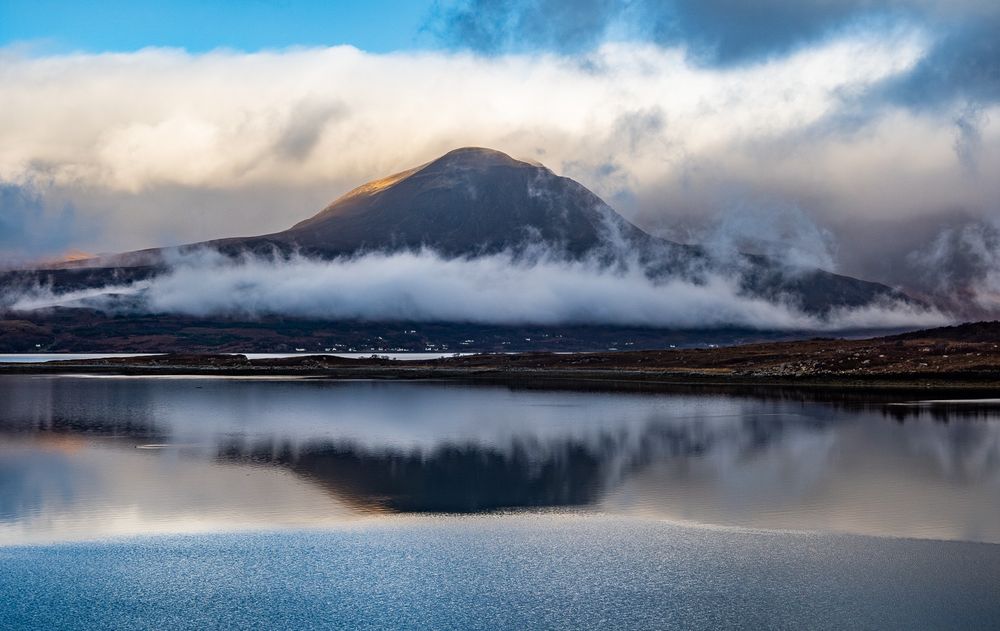 Mountain with clouds behind and below.