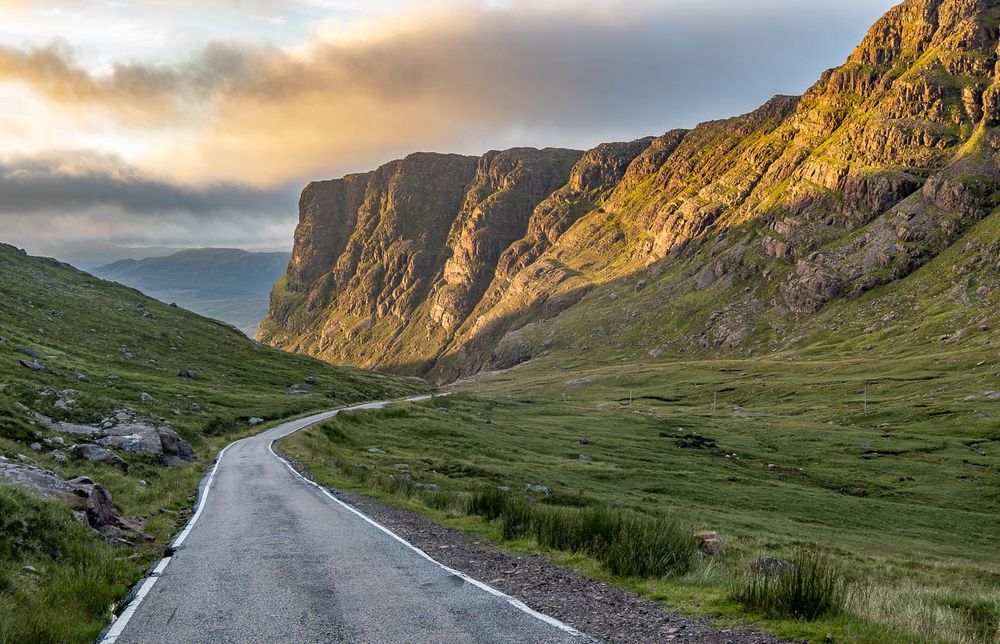 A single track road through mountains.