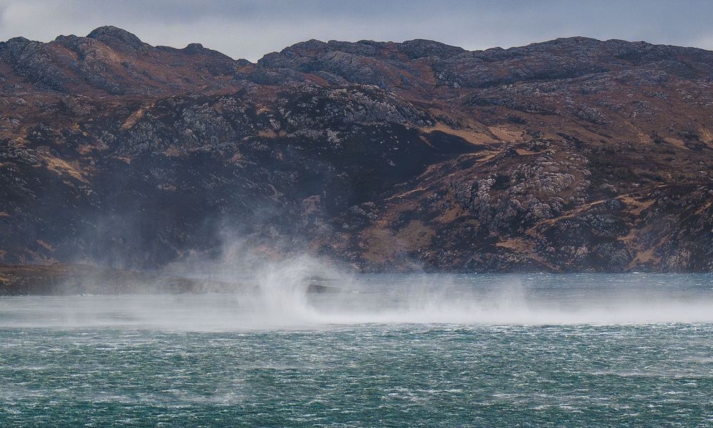 White spray over a green sea.