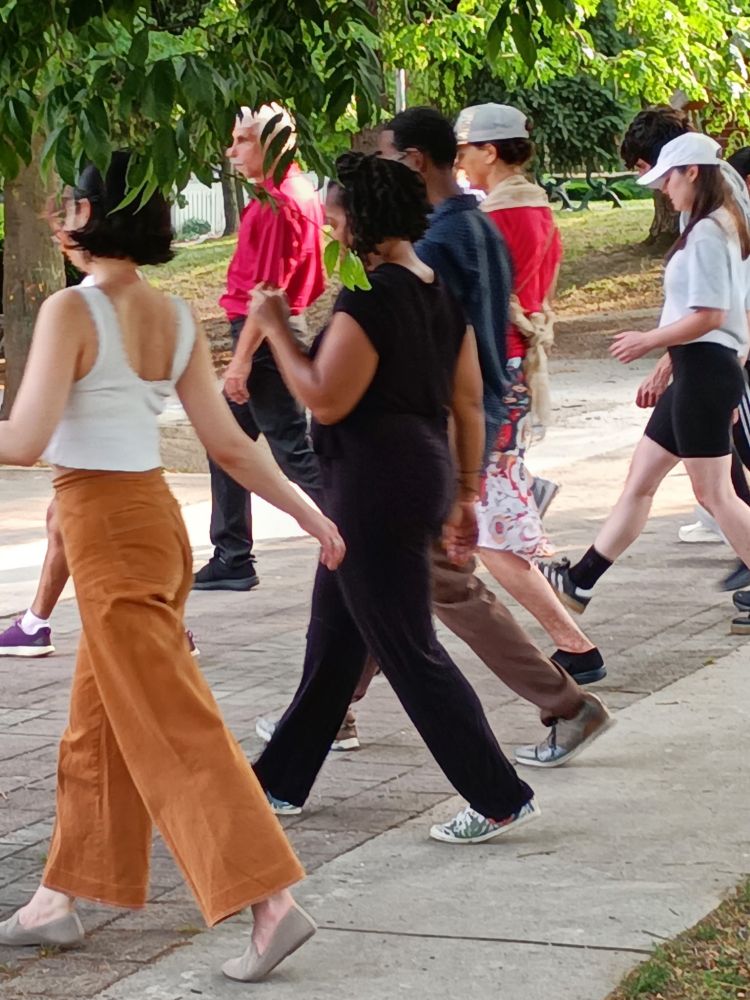 Group of people practice a forward step.