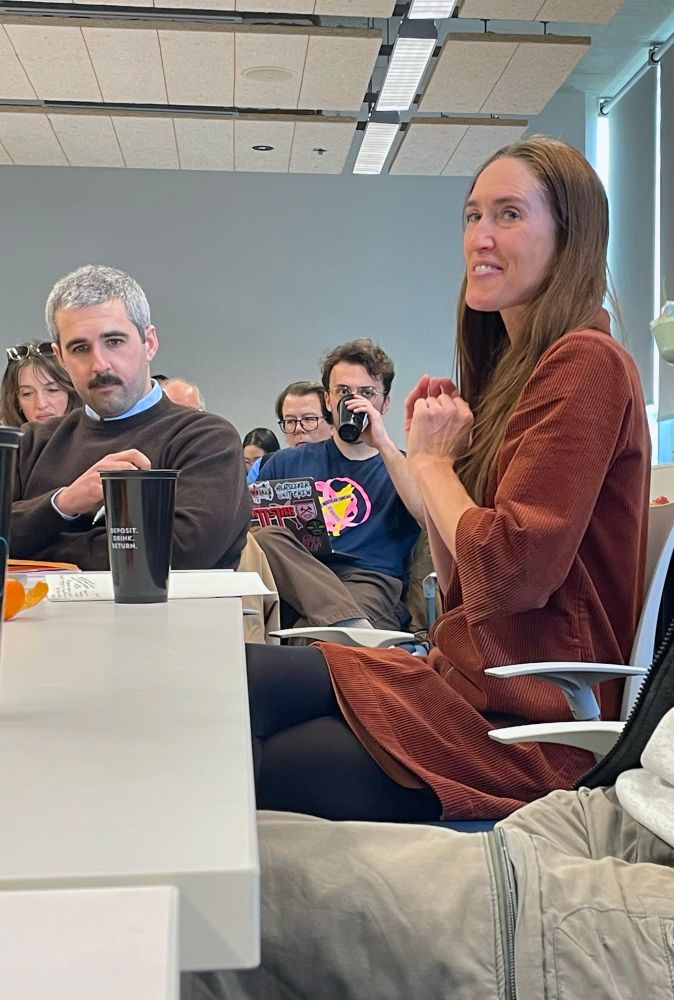 Emily Huddart sits at a table 