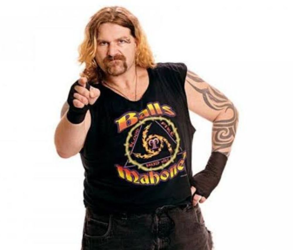 A picture of now deceased WWF wrestler Balls Mahoney. I don't know how to describe him for you but he looks the way burnt eggs smell.