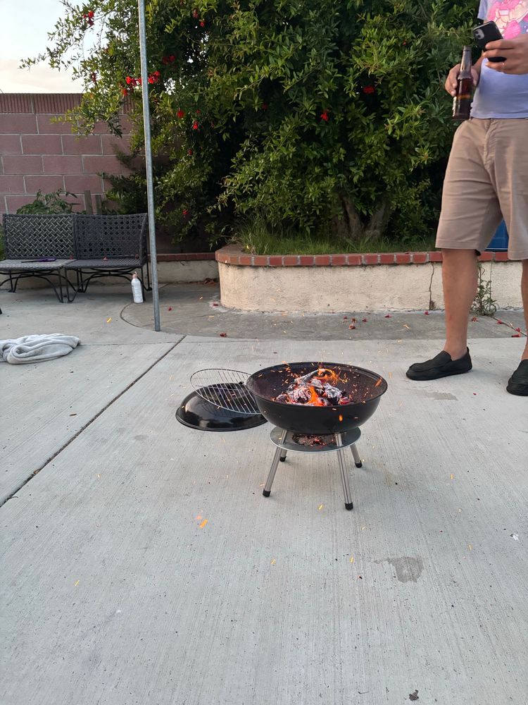 Miniature grill with hot flames kinda looking like a fireworks extravaganza if you really put your mind to it 