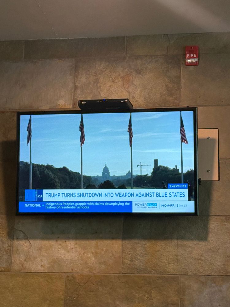 TV screen showing CTV news with American flags in the foreground and a chyron that reads, “TRUMP TURNS SHUTDOWN INTO WEAPON AGAINST BLUE STATES”.  