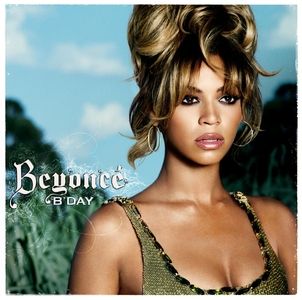 The cover art for Beyoncé's 2006 album, B'Day. A shot of Beyoncé from the chest up takes up the right side of the cover in the foreground. She's wearing a deep-cut, scoop-neck tank top that is potentially sequined and reflects a greenish-gold color. Her skin is absolutely glowing, and her caramel-highlighted hair is piled up on top of her head in either an enormous bun or a beehive (the image cuts off the top so it's unclear), with wavy pieces cascading down either side of her face and blending into her bangs.