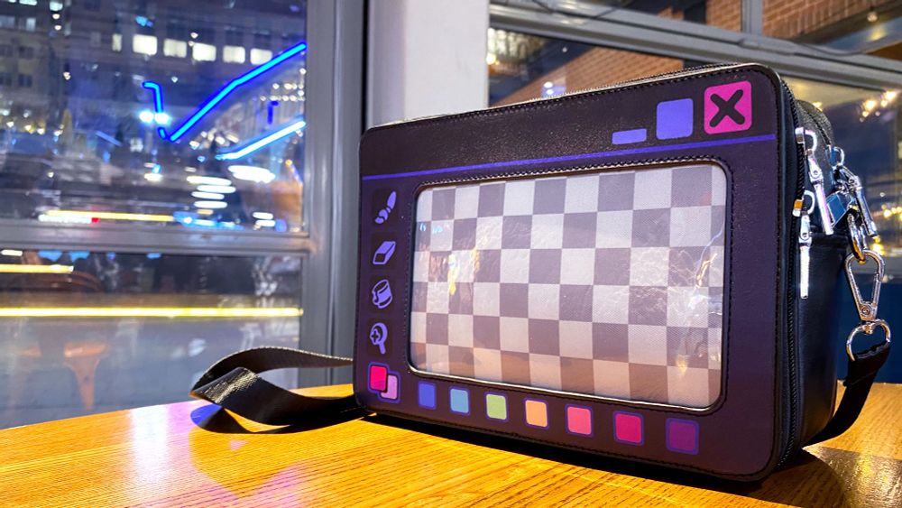 photo of the dark mode mini mx paint bag on a table