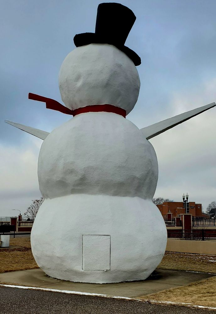 Rear view of a large snowman sculpture in North Saint Paul, MN. It has a back door.