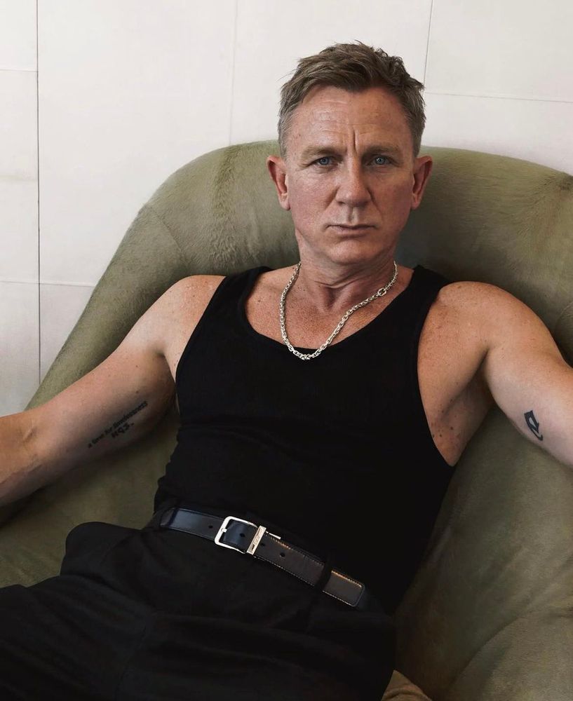 daniel craig in a tank top not drinking from a glass