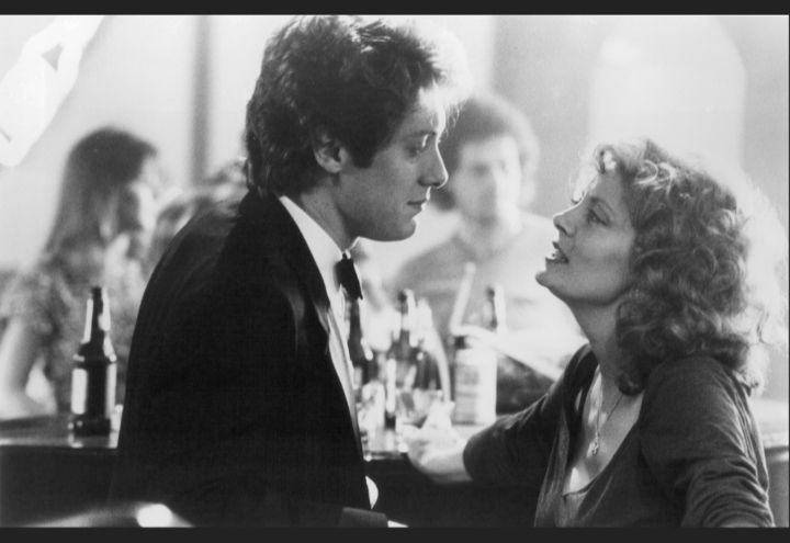 James Spader and Susan Sarandon, heating up the screen in White Palace (1990): looking into each other's eyes while standing at a bar, with bottles on the bar, with the image in black and white to make them look a bit Bogart and Bacall. Screenshot from IMDb 