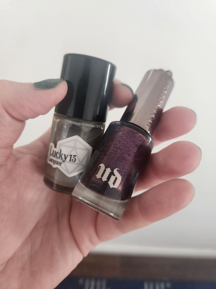 A lucky 13 holo nail polish and a purple glitter urban decay polish