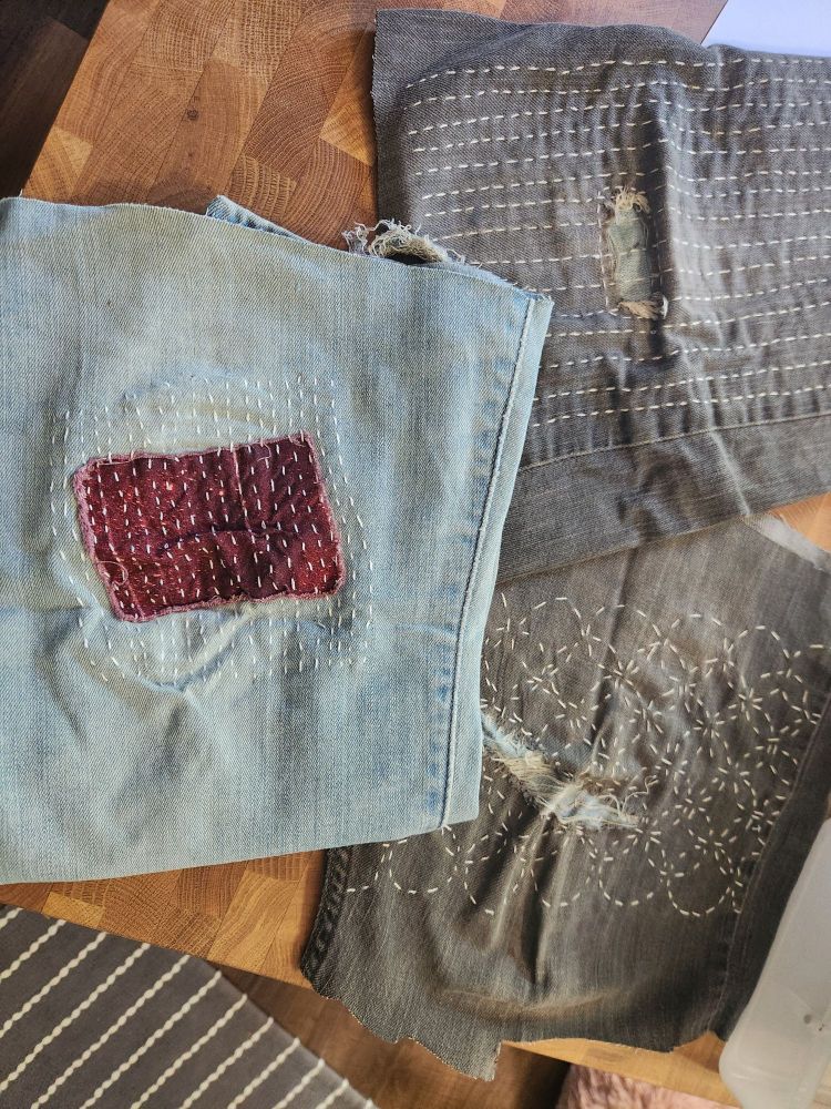 Some battered pieces of denim with sashiko patches 