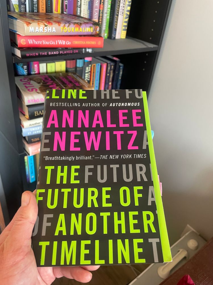 Image of book (black background, neon green + pink lettering): ANNALEE NEWITZ, THE FUTURE OF ANOTHER TIMELINE)