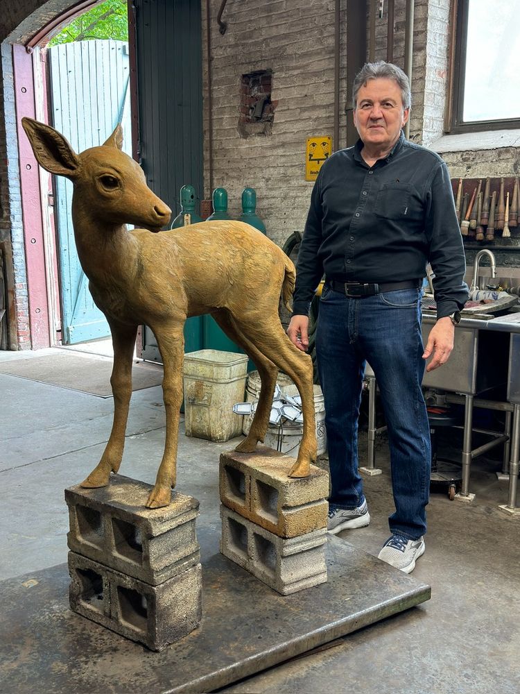 Sculptor Zenos Frudakis with sculpture of fawn at Laran Bronze foundry where it was cast in bronze. The fawn is part of a sculpture fountain at Elmwood Park Zoo in Norristown, Pennsylvania. 