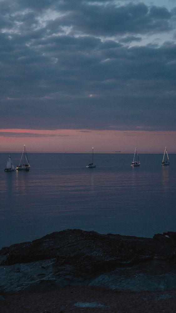 More sailing boats at sea with the Orange and blueish sky showing 