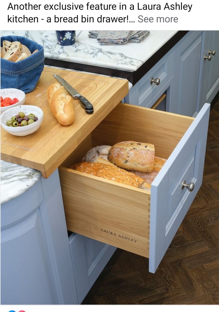 An advertisement for a Laura Ashley kitchen bread drawer, with an open drawer filled with fancy bread