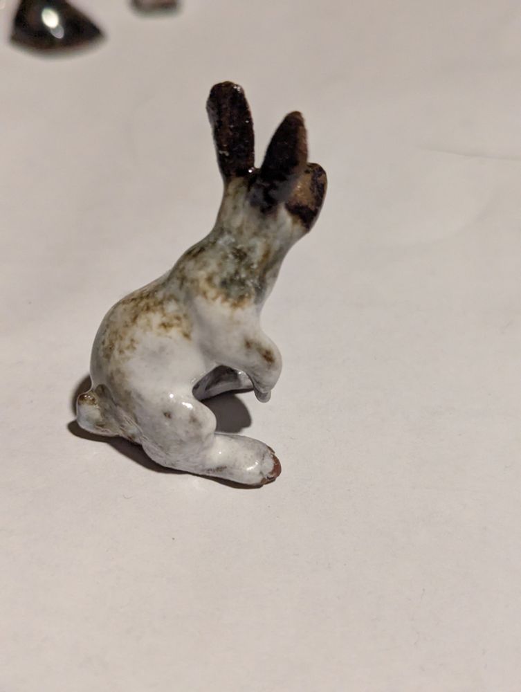 A rabbit on its hind legs glazed in white and waterfall brown