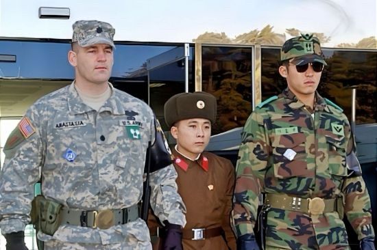 Shorter north Korean soldier stands between taller US and South Korean soldier. The North Korean only reached the shoulders of the American and South Korean.