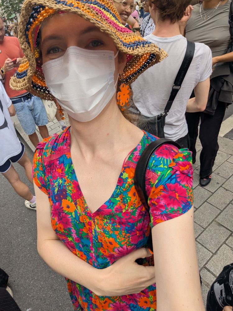 Selfie in a crowd, I'm wearing a hat, a mask and a colourful dress