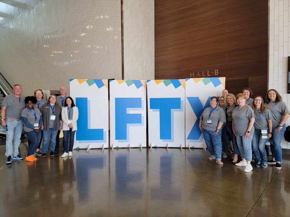 LFTX poster signs with board members beside the signs.